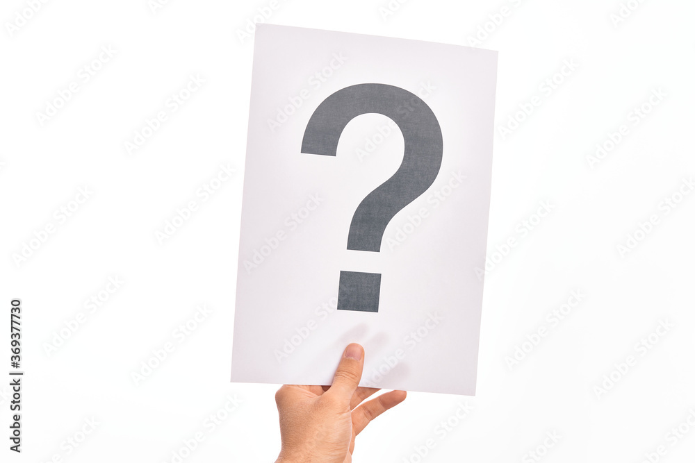 Hand of caucasian young man holding paper showing question mark over isolated white background Hand of caucasian young man holding paper showing question mark over isolated white background