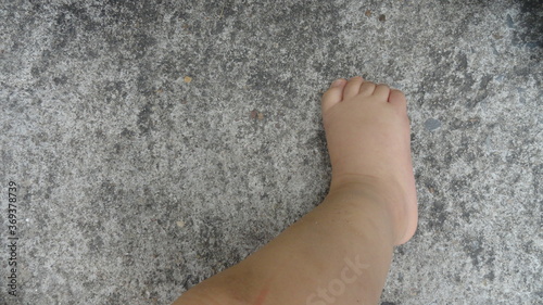 Baby foot on old cement floor background. Express the first step of everyone.
