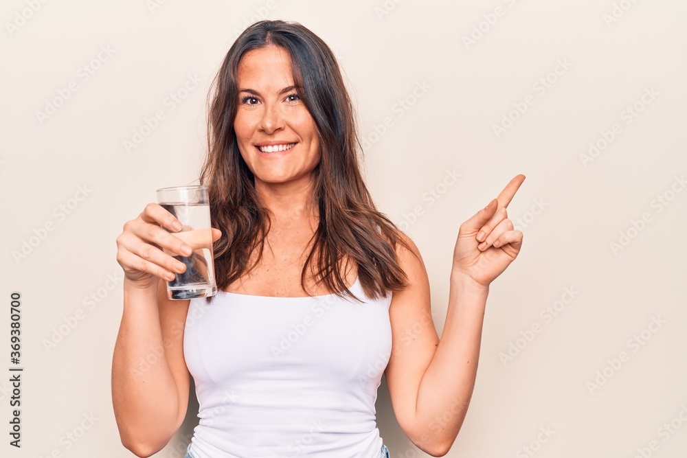 Young beautiful brunette woman wearing casual t-shirt standing over isolated white background shocked covering mouth with hands for mistake. Secret concept. Young beautiful brunette woman wearing casual t-shirt standing over isolated white background shocked covering mouth with hands for mistake. Secret concept.