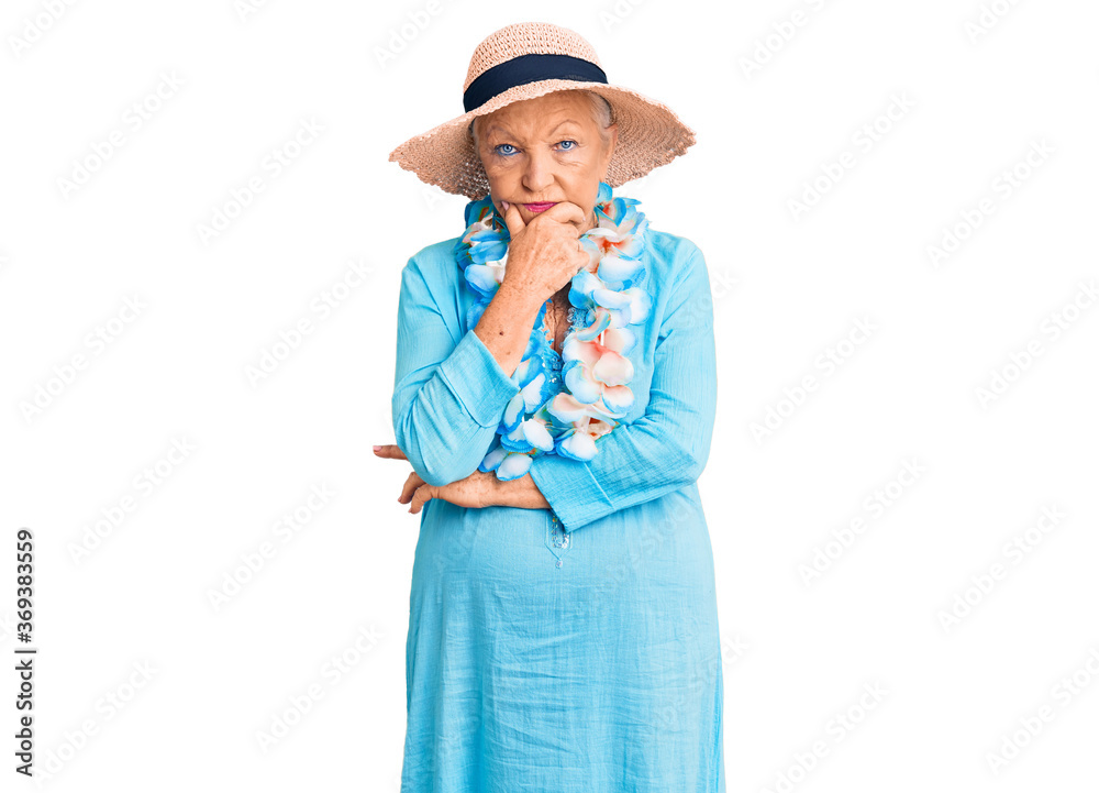 Senior beautiful woman with blue eyes and grey hair wearing summer hat and hawaiian lei thinking looking tired and bored with depression problems with crossed arms. Senior beautiful woman with blue eyes and grey hair wearing summer hat and hawaiian lei thinking looking tired and bored with depression problems with crossed arms.