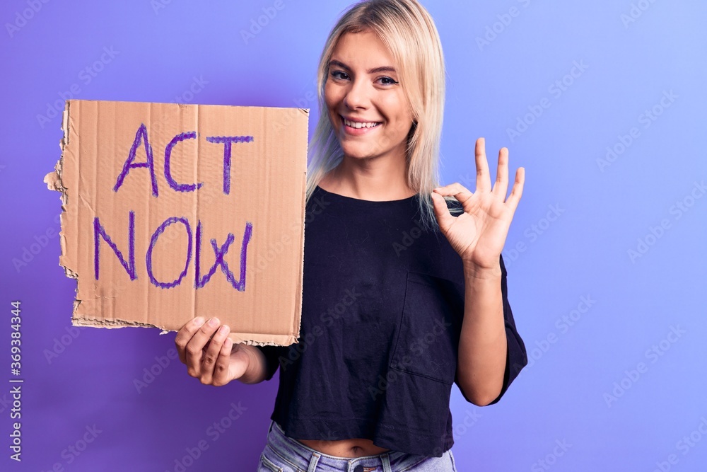 Young beautiful blonde woman asking for social reaction holding banner with act now message doing ok sign with fingers, smiling friendly gesturing excellent symbol Young beautiful blonde woman asking for social reaction holding banner with act now message doing ok sign with fingers, smiling friendly gesturing excellent symbol