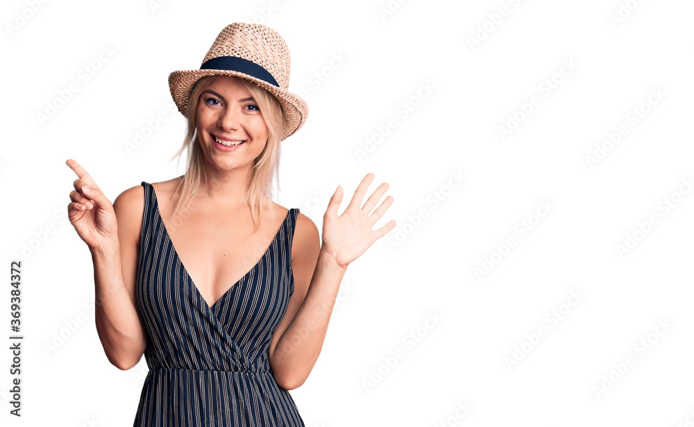 Young beautiful blonde woman wearing summer hat and dress showing and pointing up with fingers number six while smiling confident and happy. Young beautiful blonde woman wearing summer hat and dress showing and pointing up with fingers number six while smiling confident and happy.