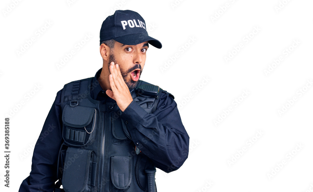 Young hispanic man wearing police uniform hand on mouth telling secret rumor, whispering malicious talk conversation Young hispanic man wearing police uniform hand on mouth telling secret rumor, whispering malicious talk conversation