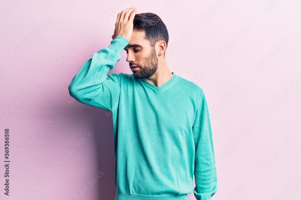 Young handsome man with beard wearing casual sweater surprised with hand on head for mistake, remember error. forgot, bad memory concept. Young handsome man with beard wearing casual sweater surprised with hand on head for mistake, remember error. forgot, bad memory concept.