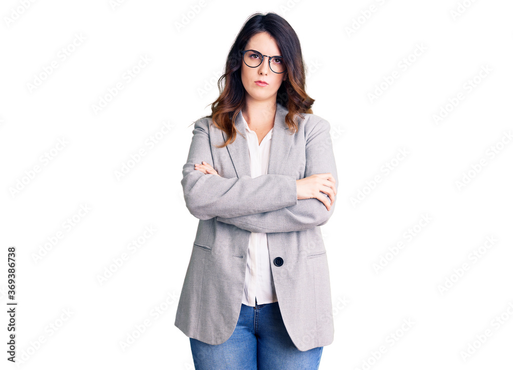 Beautiful young brunette woman wearing business clothes and glasses skeptic and nervous, disapproving expression on face with crossed arms. negative person. Beautiful young brunette woman wearing business clothes and glasses skeptic and nervous, disapproving expression on face with crossed arms. negative person.