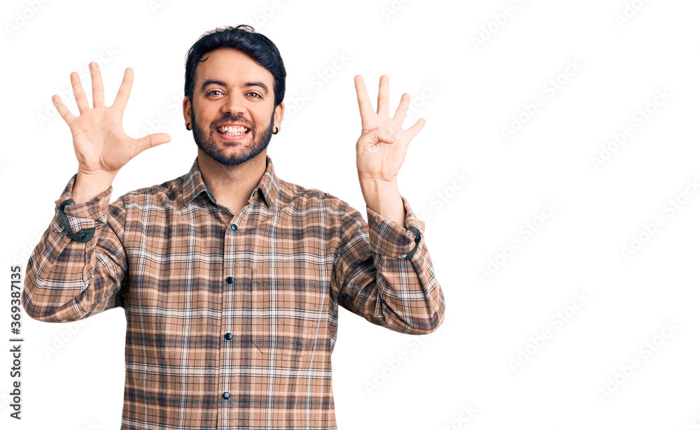 Young hispanic man wearing casual clothes showing and pointing up with fingers number nine while smiling confident and happy. Young hispanic man wearing casual clothes showing and pointing up with fingers number nine while smiling confident and happy.