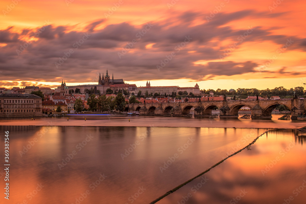 Prague Castle and Charles Bridge through Vltava river at sunset ,Czech Republic