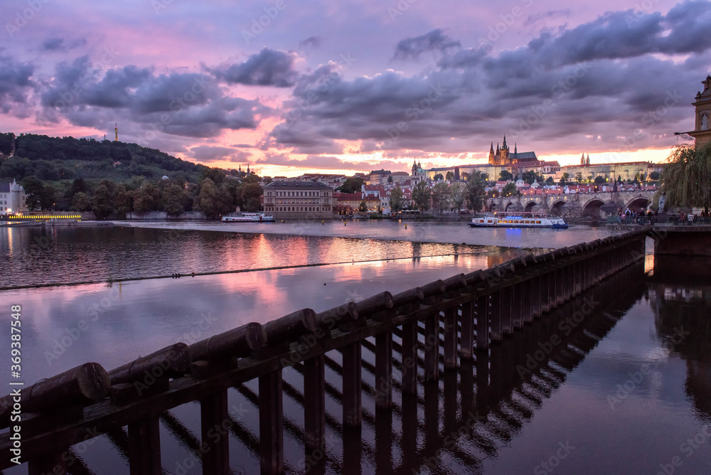 Prague Castle and Charles Bridge through Vltava river at sunset ,Czech Republic