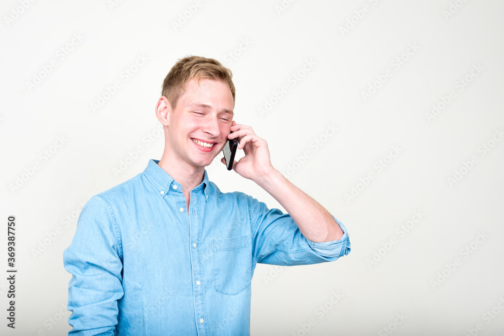 Portrait of happy young handsome blond businessman talking on the phone Portrait of happy young handsome blond businessman talking on the phone