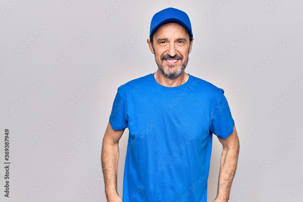 Middle age handsome deliveryman wearing cap standing over isolated white background with a happy and cool smile on face. Lucky person. Middle age handsome deliveryman wearing cap standing over isolated white background with a happy and cool smile on face. Lucky person.