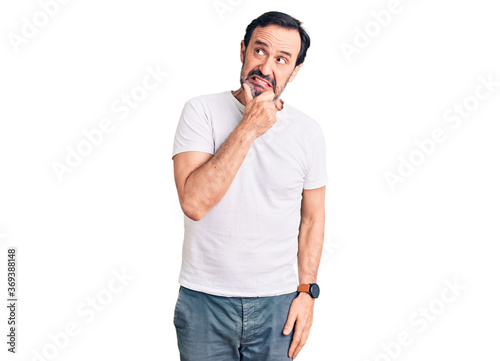 Middle age handsome man wearing casual t-shirt thinking worried about a question  concerned and nervous with hand on chin