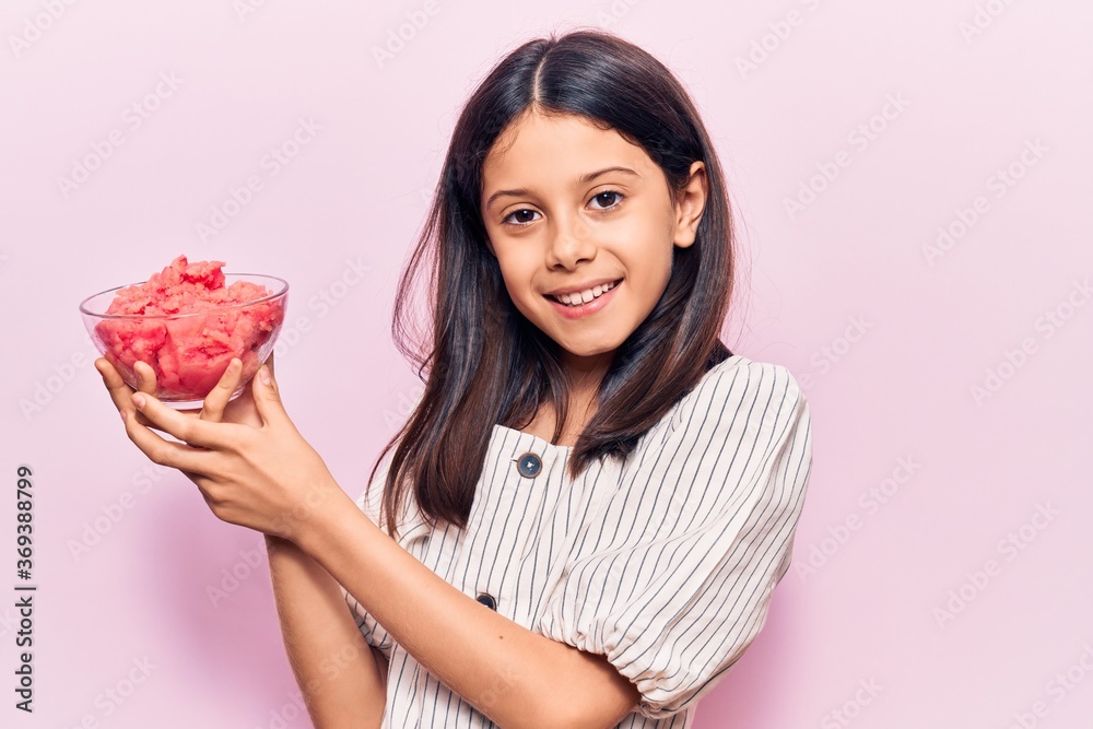 Beautiful child girl holding ice cream looking positive and happy standing and smiling with a confident smile showing teeth Beautiful child girl holding ice cream looking positive and happy standing and smiling with a confident smile showing teeth