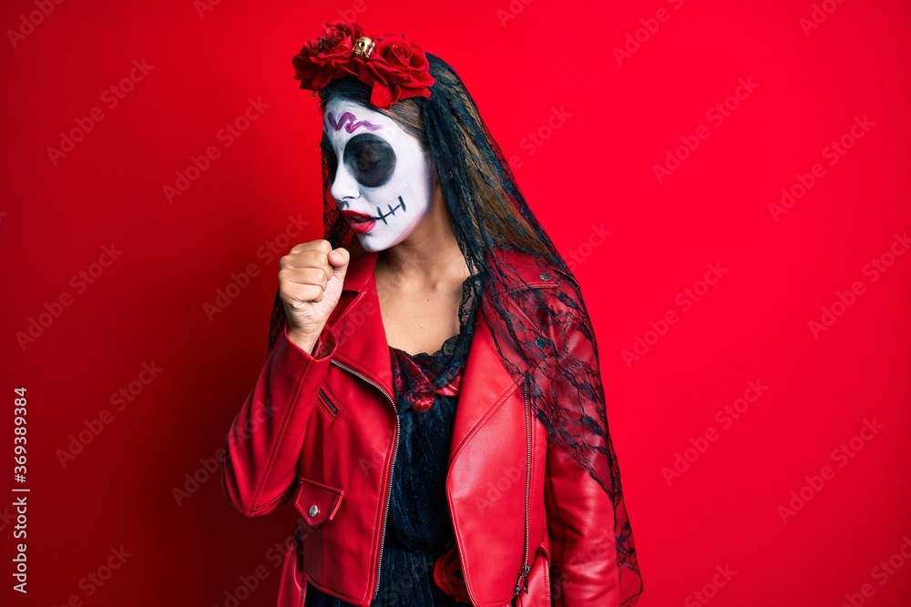 Woman wearing day of the dead costume over red feeling unwell and coughing as symptom for cold or bronchitis. health care concept.