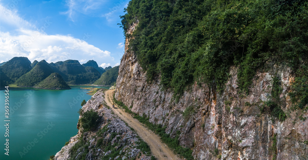 aerial view of a villager is riding on tough high mountain road