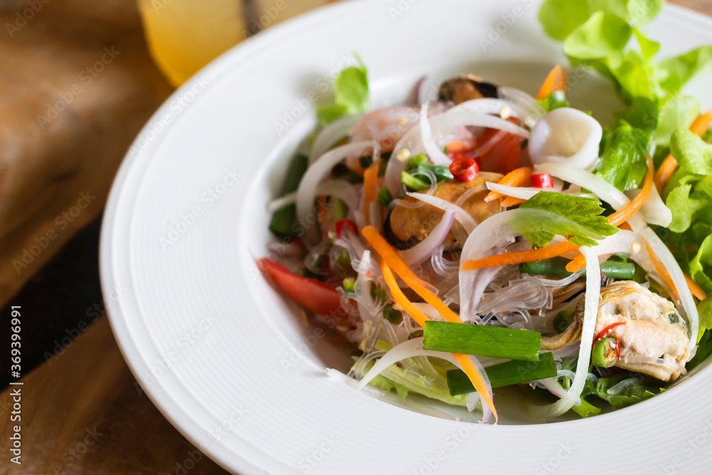 Spicy noodle salad With Vietnamese sausage and shrimp and squid