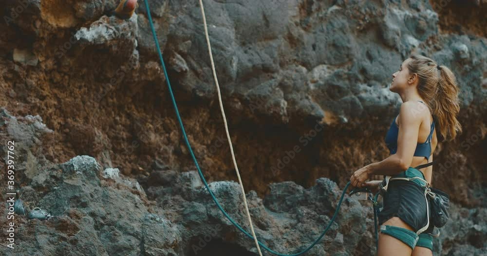 Young woman preparing to rock climb, healthy lifestyle and fitness Young woman preparing to rock climb, healthy lifestyle and fitness