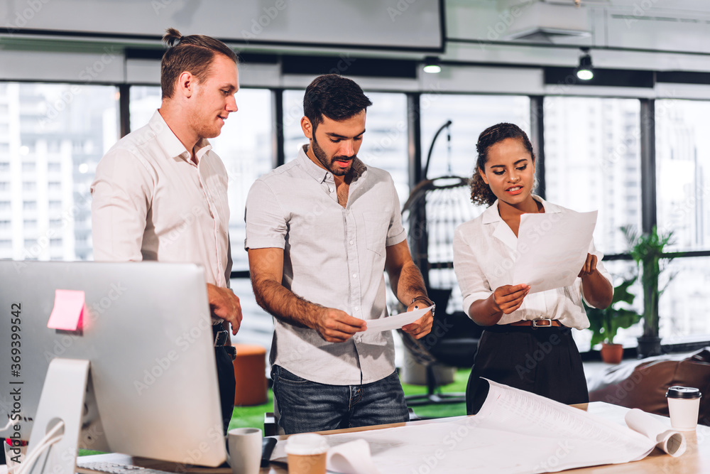 Naklejka premium Group of professional business meeting and discussing strategy with new startup project.Creative business people planning and brainstorm with document report in modern workloft.Teamwork concept
