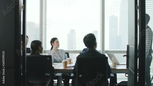 team of asian business people meeting in modern office conference room