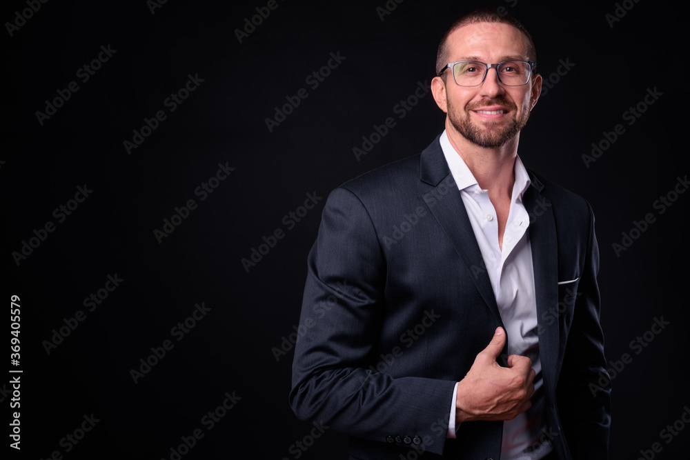 Portrait of happy handsome bearded businessman with eyeglasses Portrait of happy handsome bearded businessman with eyeglasses