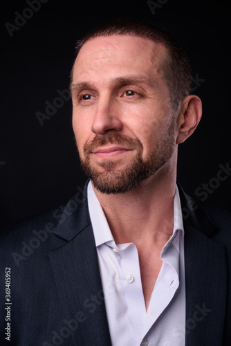 Portrait of handsome bearded businessman in suit