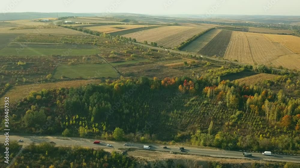 AERIAL View Flying Above Stunning Fall Nature and Road Running Through Picturesque Countryside. Road in Autumn Scenery Aerial Shot. Car Driving Road Leading Through Colorful Landscape on Autumn Day. AERIAL View Flying Above Stunning Fall Nature and Road Running Through Picturesque Countryside. Road in Autumn Scenery Aerial Shot. Car Driving Road Leading Through Colorful Landscape on Autumn Day.