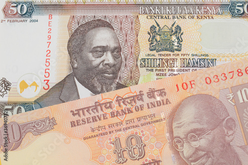 Wallpaper Mural A macro image of a orange ten rupee bill from India paired up with a colorful fifty shilling bank note from Kenya.  Shot close up in macro. Torontodigital.ca