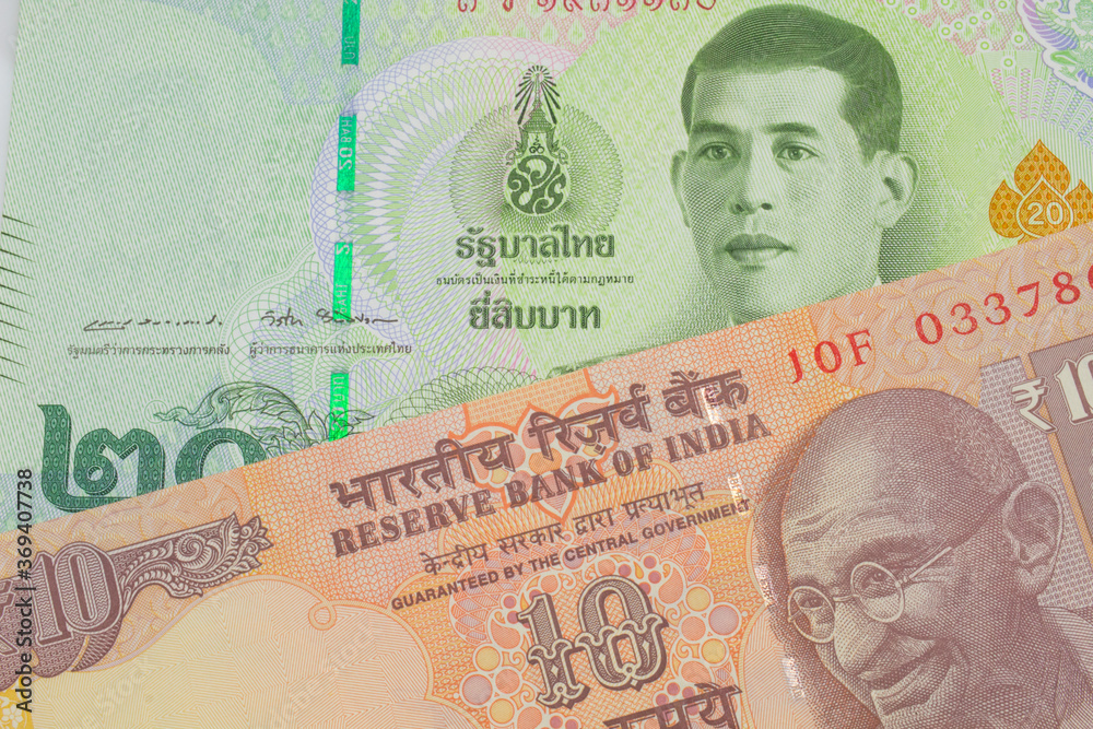 custom made wallpaper toronto digitalA macro image of a orange ten rupee bill from India paired up with a green twenty baht bank note from Thailand. Shot close up in macro.