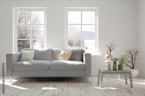 White stylish minimalist room with sofa and winter landscape in window. Scandinavian interior design. 3D illustration © AntonSh