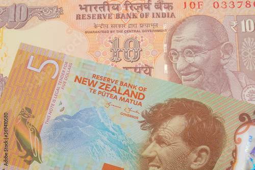 Wallpaper Mural A macro image of a orange ten rupee bill from India paired up with a orange, plastic five dollar bill from New Zealand.  Shot close up in macro. Torontodigital.ca