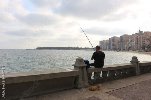 A young man fishing on the sea