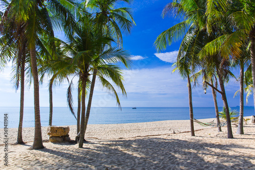 Beautiful beach in Thailand. View of sunlight tropical sea beach with coconuts palms. Tropical sand beach holiday for background and vacation travel concept.