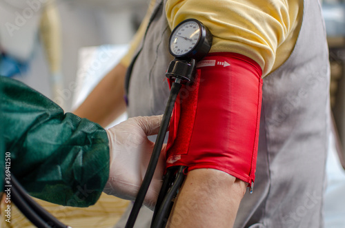 Doctor Checking the Blood Pressure of a Woman photo