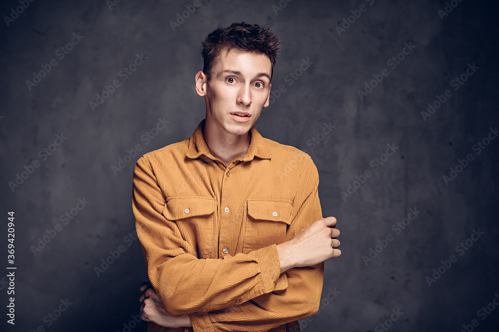 Surprised young caucasian man on dark background Surprised young caucasian man on dark background