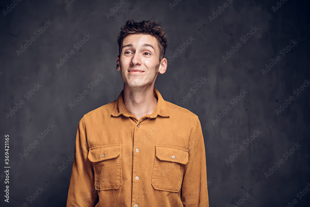 Worried young caucasian man on dark background