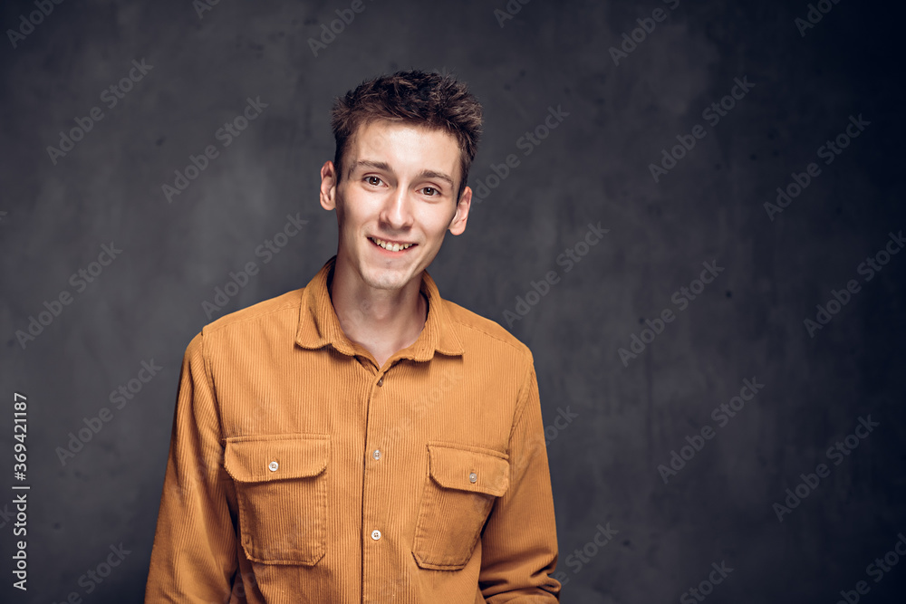 Happy young caucasian man on dark background Happy young caucasian man on dark background