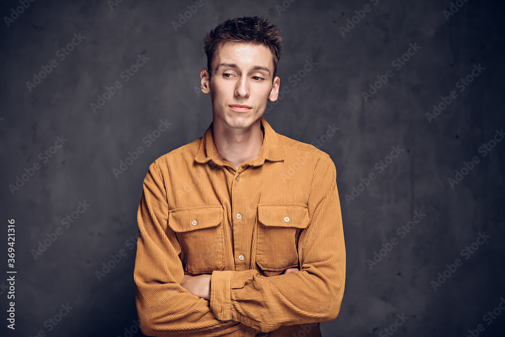 Pensive young caucasian man on dark background