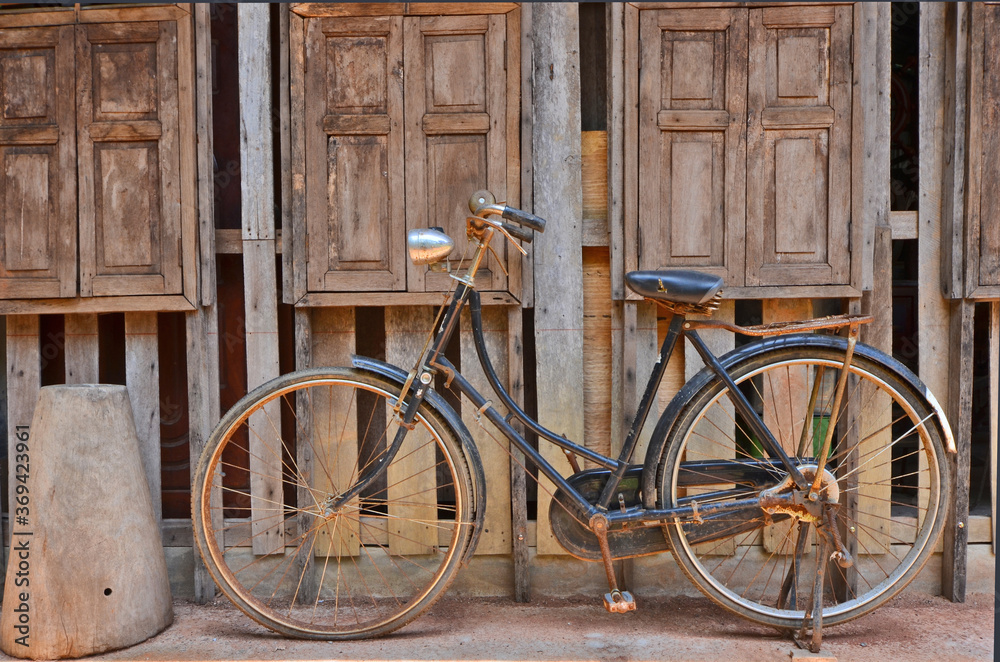 Fototapeta premium Old woman bicycle beside the windows of storage warehouse1