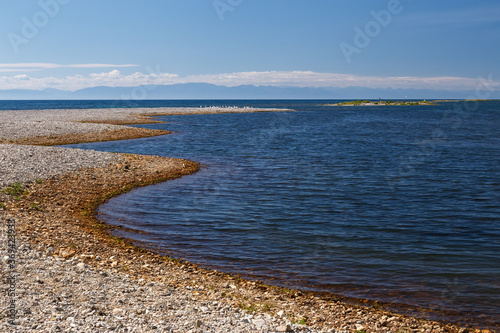 Shore line of Baikal lake in Russia with clear water and blue sky