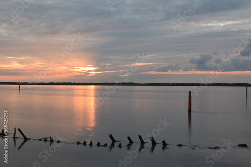 Long exposure golden sunset over Breydon Water, a stretch of the River Yare at Great Yarmouth, Norfolk, UK photo