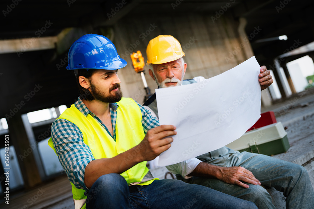 Fototapeta premium Team of construction engineers, architects working on building site