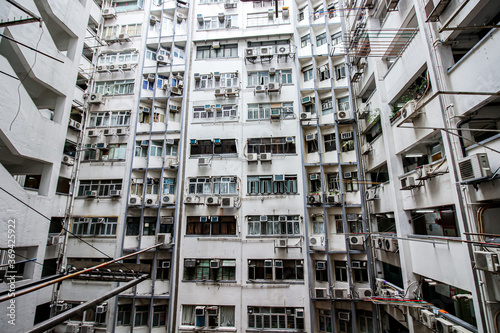 Low angle view of crowded residential towers in an old community in Hong Kong. Scenery of overcrowded narrow apartments, high housing density in Hongkong.