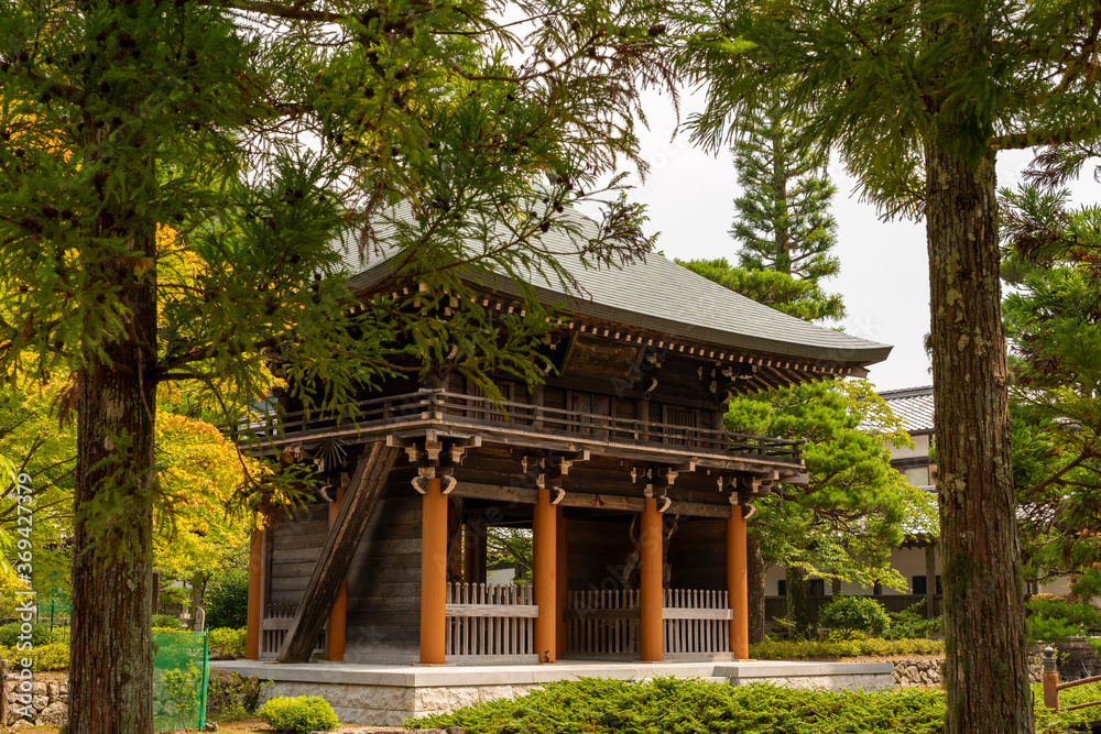 A gate with the statue of a Deva king standing on either side of Yotaku-ji temple in Sanda-shi, Hyogo, Japan