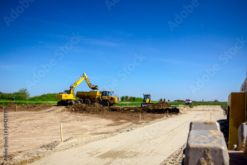 Fotografie Close up view on spikes of road roller for compacting soil at construction site