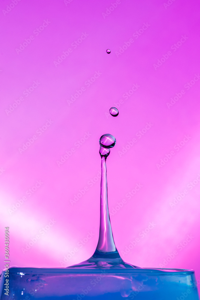 Water Drop Collisions Macro Photography with pink background	