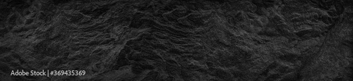 Black white abstract background. Black stone background. Dark gray grunge background. Wide banner with rock texture.