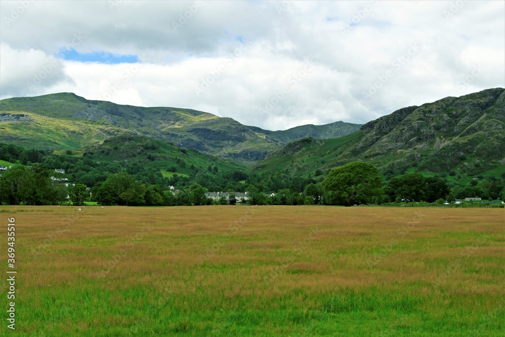 Mountain landscape with green grass and clouds, in Coniston, in the Lake District, Cumbria, England,