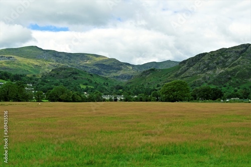 Mountain landscape with green grass and clouds, in Coniston, in the Lake District, Cumbria, England,