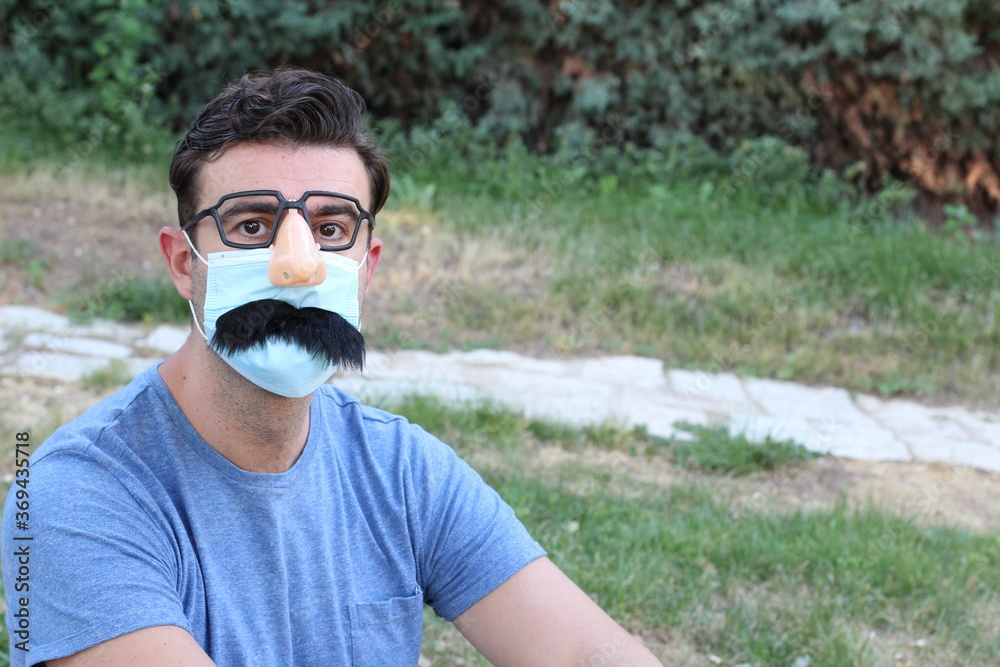 Man wearing fake nose, eyeglasses, mustache and PPE Man wearing fake nose, eyeglasses, mustache and PPE