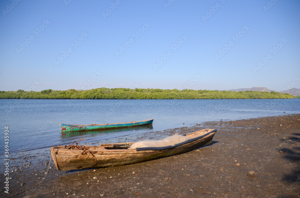 View of the Estuary Padre Ramos Natural Reserve in Nicaragua, its inhabitants are mainly fisherman. Old traditional fishing boats in the shore of the mangrove.  water. 