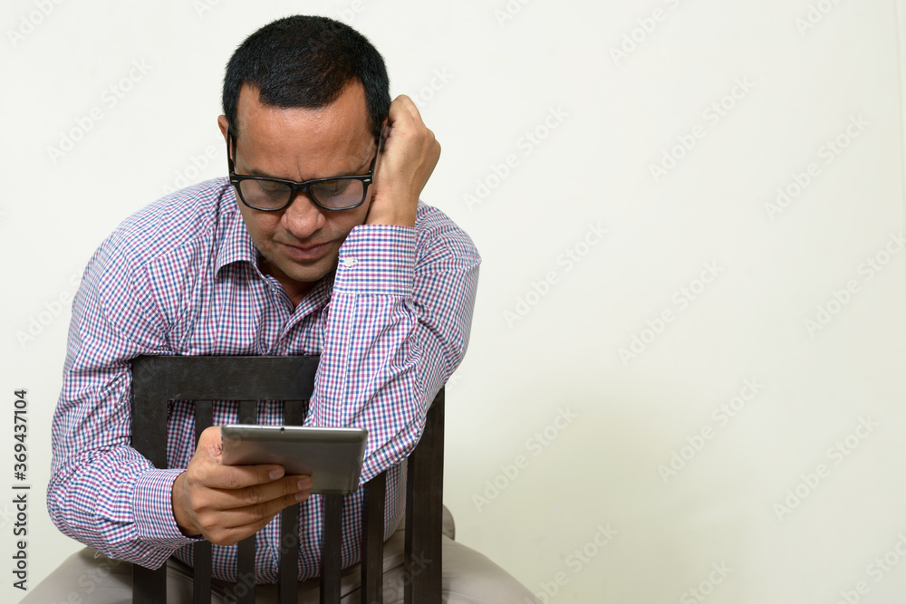 Portrait of overweight Indian businessman with digital tablet Portrait of overweight Indian businessman with digital tablet